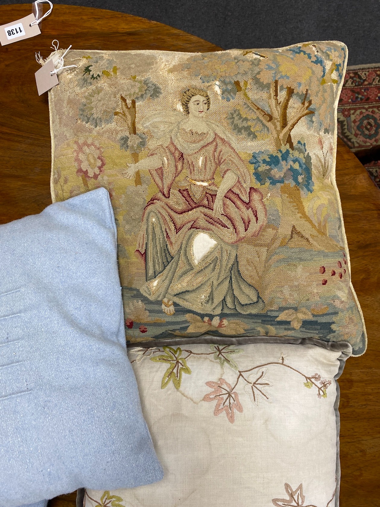 A 19th century petit point polychrome tapestry now as a cushion, 48cm x 46cm together with four later cushions.